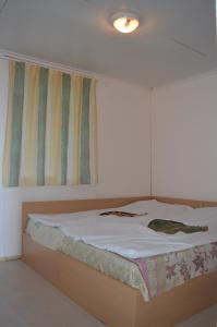 a large bed in a room with avertisementatronatronstrationstrationstration at Letovishte Romantika in Kamchia