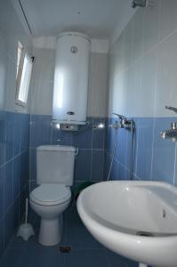 a bathroom with a white toilet and a sink at Letovishte Romantika in Kamchia +52 photos