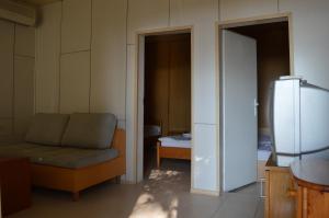 a living room with a couch and a refrigerator at Letovishte Romantika in Kamchia