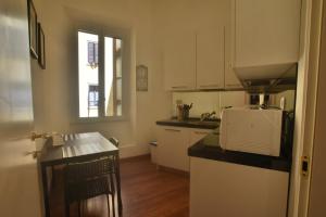 a kitchen with white cabinets and a counter top at Piano Suite in Vatican in Rome