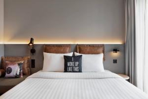 Voodi või voodid majutusasutuse Moxy Rapperswil toas