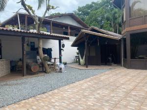 a dog standing in front of a house at Quarto ECONÔMICO - Suíte in Camboriú