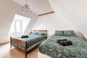a bedroom with a large bed and a window at 300m2 house with large garden in Villuis