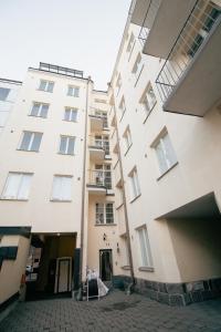 a tall white building with a sign in front of it at Lovely Flat in the Heart of Helsinki in Helsinki