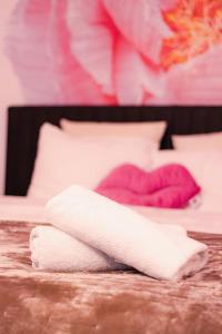 a white towel sitting on top of a bed at Lovely Flat in the Heart of Helsinki in Helsinki