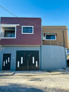 a building with two garage doors on the side of it at Conchita's, near Mall metrocentro, AC, SHW in Santa Ana