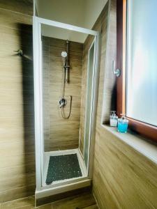 a shower with a glass door in a bathroom at Casa Adele in Salerno +14 photos