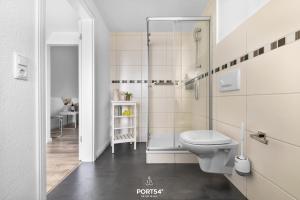a bathroom with a toilet and a glass shower at Apartment 25 in Kappeln