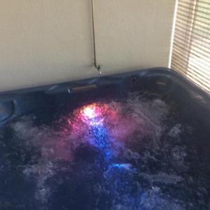 a hot tub with a colorful light in a room at Quinta dos Castanheiros - Turismo Rural in Negreda