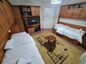 a bedroom with two beds and a coffee table at Tirana Center in Tirana