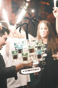 a man and woman holding a tray of glasses at DownTown Tulum Hotel in Tulum +58 photos