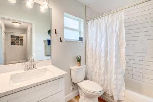 a white bathroom with a toilet and a sink at 1 Mi to Links! Resort Home Near Raceway in Sebring in Sebring +24 photos