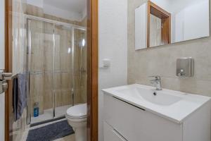 a bathroom with a toilet and a sink and a shower at Tulum Airostel in San Isidro +11 photos