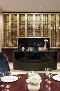 a dining room with a table with wine glasses at The St. Regis Chengdu in Chengdu
