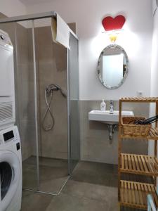 a bathroom with a shower and a sink and a washing machine at Beautiful Apartment with Parking, Brilliant Location in Vienna