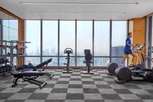 a woman running on a treadmill in a gym at The Westin Jakarta in Jakarta +92 photos