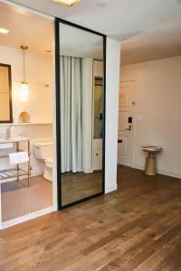 a large mirror in a room with a bathroom at The Alida, Savannah, a Tribute Portfolio Hotel in Savannah