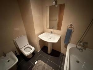 a bathroom with a sink and a toilet and a tub at Appartement haut standing Mohammedia Parc in Mohammedia +3 photos