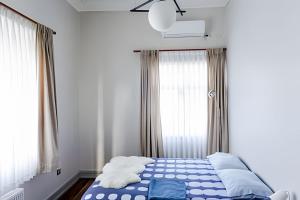 a bedroom with a bed with blue and white sheets at Habitación a orilla del río in Valdivia