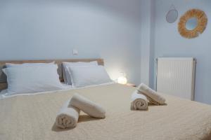 a bedroom with a bed with towels on it at Almond's Room in Mirina