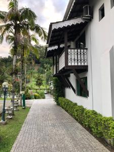 a walkway next to a building with a balcony at Hotel Quinta da Bica D'Água in Florianópolis