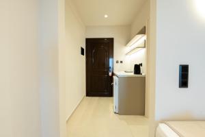 a small kitchen with a refrigerator and a counter at Hotel Areti in Neos Marmaras