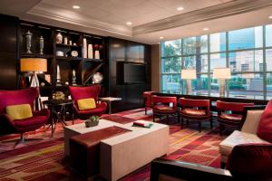 a living room with red chairs and a large window at Las Vegas Marriott in Las Vegas