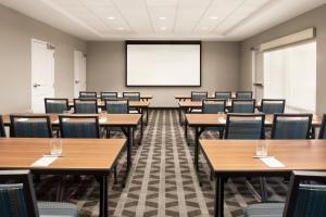 a classroom with tables and chairs and a projection screen at TownePlace Suites by Marriott Janesville in Janesville +21 photos