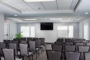 a room with rows of chairs and a flat screen tv at TownePlace Suites by Marriott Waco South in Waco +14 photos