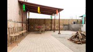 a patio with chairs and a table in a building at Joey's Hostel Delhi in New Delhi