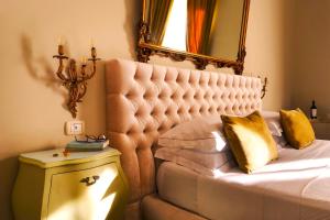 a bedroom with a bed with a mirror on the wall at B&B Palazzo Cerami in Catania