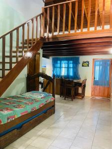 a bedroom with a bunk bed and a staircase at Cómodo town-house con piscina in El Marite