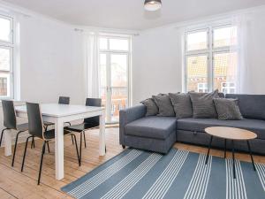 a living room with a couch and a table at Holiday home in Denmark in Ringkøbing