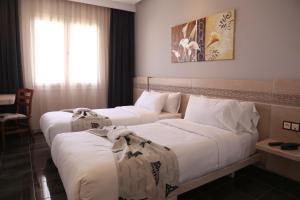 A bed or beds in a room at Hotel A44