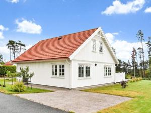 a white house with a red roof at 5 star holiday home in ENGELSVIKEN in Saltnes