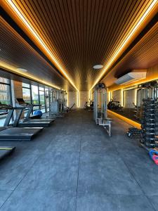 a gym with a row of treadmills and machines at Porto Alto Resort - Porto de Galinhas in Porto De Galinhas