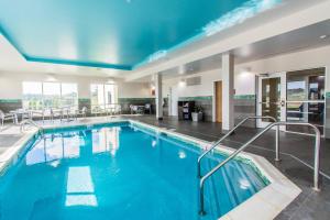 a large swimming pool in a hotel room at TownePlace Suites by Marriott Evansville Newburgh in Newburgh