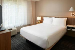 a hotel room with a large bed and a window at TownePlace Suites Winchester in Winchester +16 photos