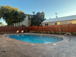 a swimming pool in a yard next to a fence at Holualoa Gardens 103 in Kailua-Kona