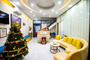 a living room with a christmas tree in the middle at Teddy 96 Homestay & Cafe-3 stars-Grand World Phu Quoc in Phu Quoc
