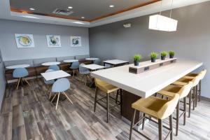 a dining room with a large white table and chairs at TownePlace Suites by Marriott Bowling Green in Bowling Green +15 photos