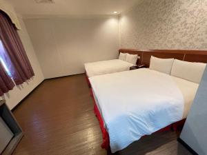 a room with two beds in a hotel room at The Prince Hotel in Tainan +16 photos