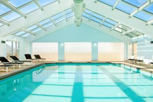 a pool with chairs and a swimming pool at Sheraton Myrtle Beach in Myrtle Beach