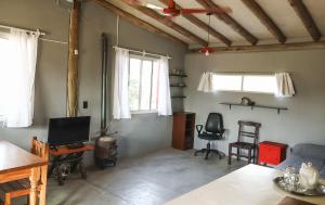 a living room with a table and chairs and windows at El Ashva casa de campo y santuario de caballos in Las Calles