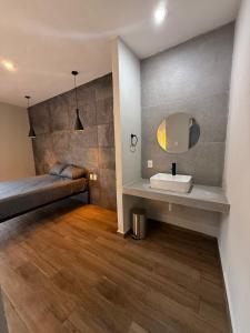 a bathroom with a sink and a mirror at La Gran Manzana in Tizimín +2 photos