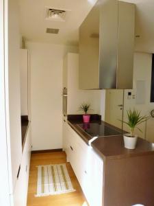 a kitchen with white cabinets and a black counter top at Apartamentos Nazareno in Seville