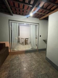 a room with a table and a glass window at Casa gravata de penha in Penha
