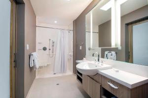 a bathroom with a sink and a shower at SpringHill Suites by Marriott Miami Doral in Miami