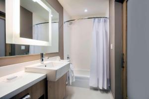 a white bathroom with a sink and a shower at SpringHill Suites by Marriott Miami Doral in Miami +15 photos