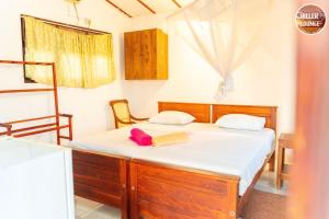 a bedroom with a bed with white sheets at Chiller Jone's place in Tangalle
